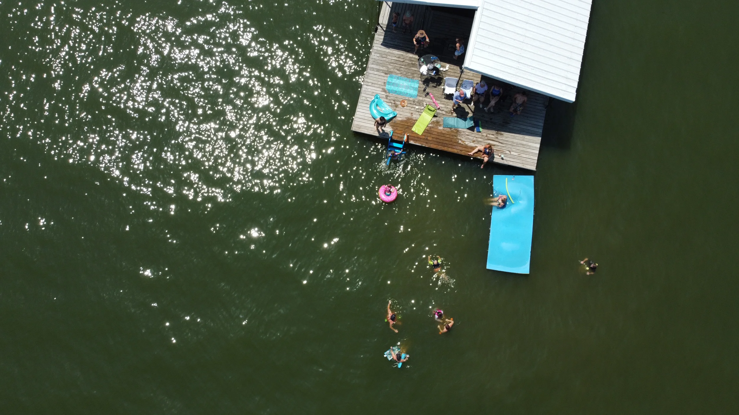 people swimming off of the docks